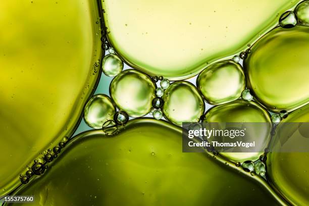 oil & water - abstract background green macro - oil stock pictures, royalty-free photos & images