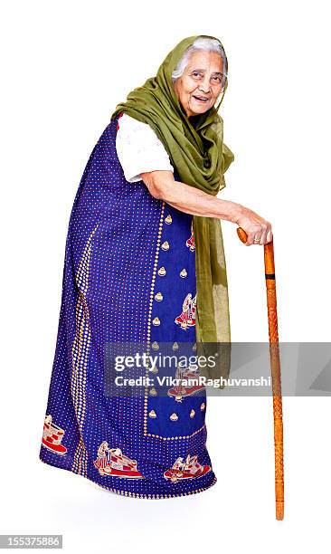 cheerful indian senior aged woman with walking stick full length - indian crutch stockfoto's en -beelden