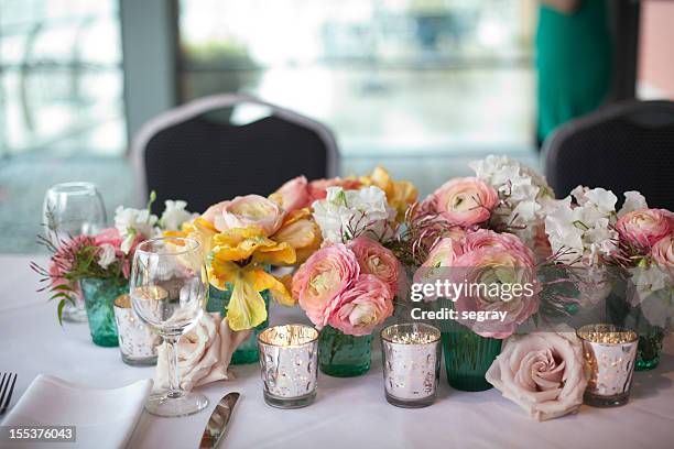 spring flower centerpiece on dining table - votive candle stock pictures, royalty-free photos & images