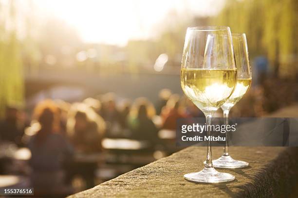 two glasses of white wine on sunset - focus on foreground food stock pictures, royalty-free photos & images