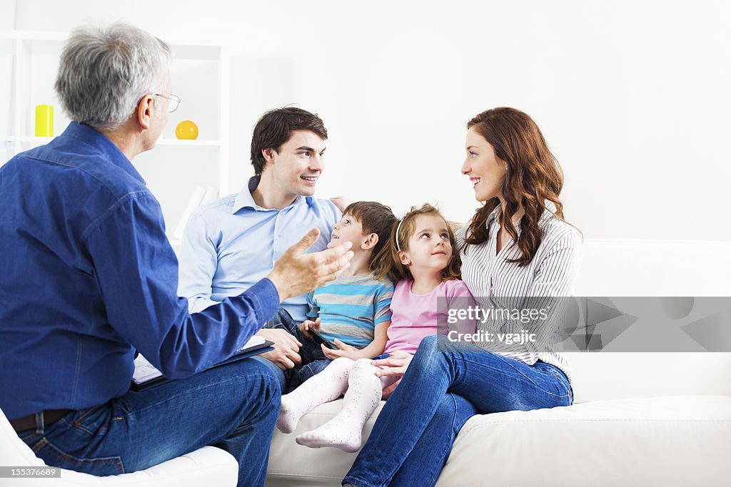 Counselor talking to man, wife and two children