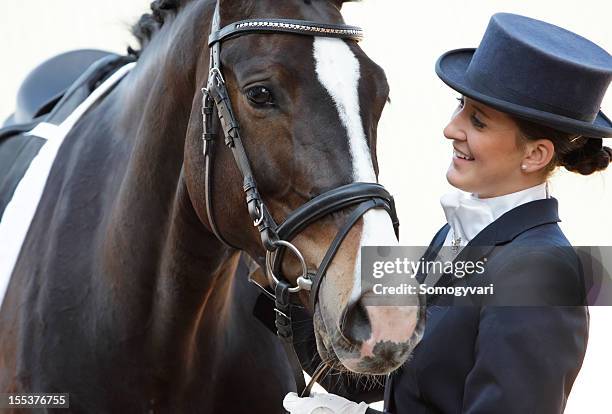 dressage rider with her horse - dressage stockfoto's en -beelden