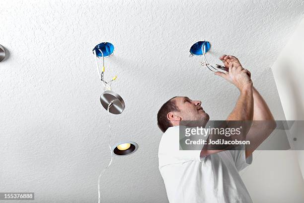 real electrician hanging fixtures - suspended ceiling stock pictures, royalty-free photos & images