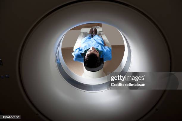 man having a medical examination via mri scan - radiotherapy stock pictures, royalty-free photos & images