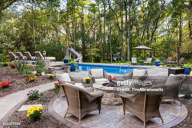 patio fire pit by swimming pool - garden terrace stock pictures, royalty-free photos & images