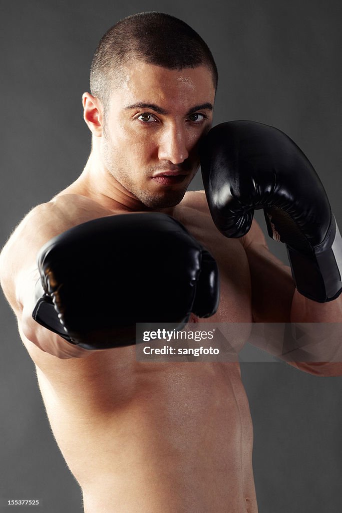 Boxer punching with gloves