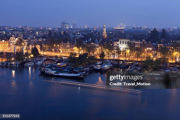 aerial view of city harbour at night, amsterdam, the netherlands - amsterdam skyline stockfoto's en -beelden
