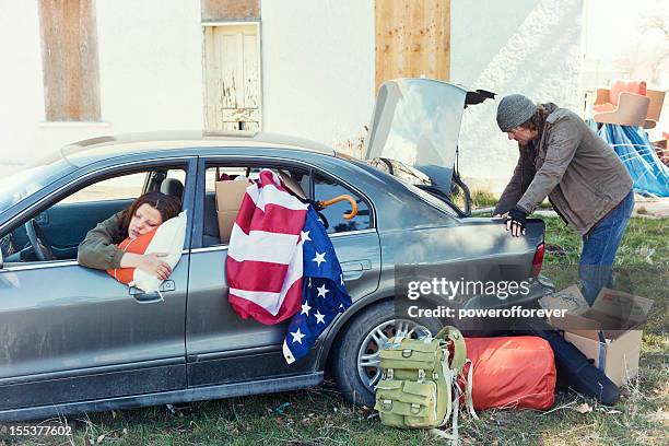 homeless couple living out of a car - homeless with american flag stock pictures, royalty-free photos & images