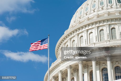 American flag waving in front of Capitol Hill American flag waving in front of Capitol Hill