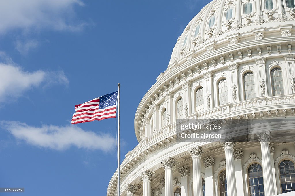 American flag waving in front of Capitol Hill