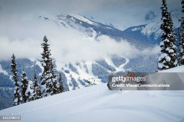 snowmobiling on the top of the snowy mountain - snow vehicle stock pictures, royalty-free photos & images