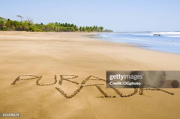 pura vida written on costa rican beach - ogphoto and costa rica stock pictures, royalty-free photos & images