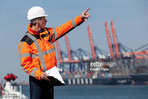 dockworker giving instructions - moored stock pictures, royalty-free photos & images
