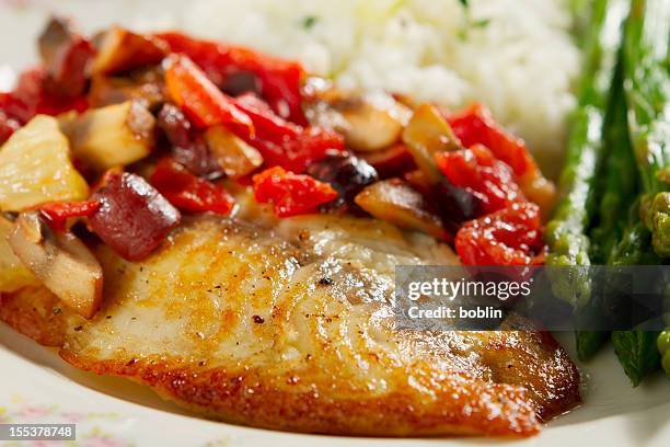 tilapia with mediterranean style relish - tilapia stock pictures, royalty-free photos & images