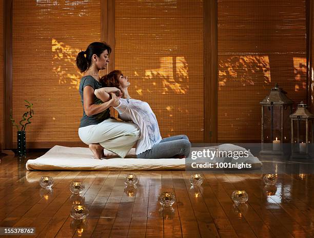 thai massage - massage therapy stock pictures, royalty-free photos & images