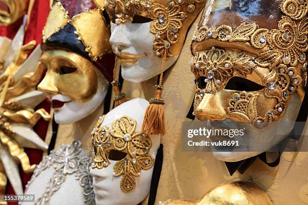 high quality carnival masks hanging on the wall - venetiaans masker stockfoto's en -beelden