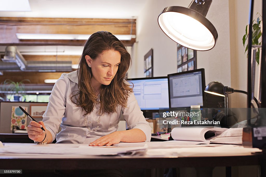 Businesswoman studies paperwork