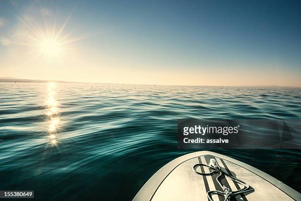 speedboat on lake driving against sun - bodensee stock pictures, royalty-free photos & images