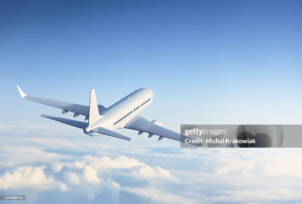 Commercial jet flying over clouds