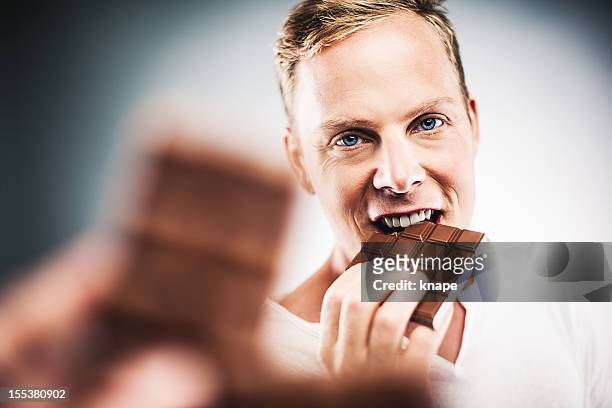 man eating chocolate - chocolate face stock pictures, royalty-free photos & images