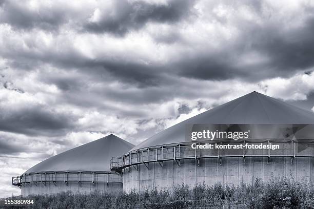 biomass energy plant under an approaching thunderstorm - biogas stock pictures, royalty-free photos & images