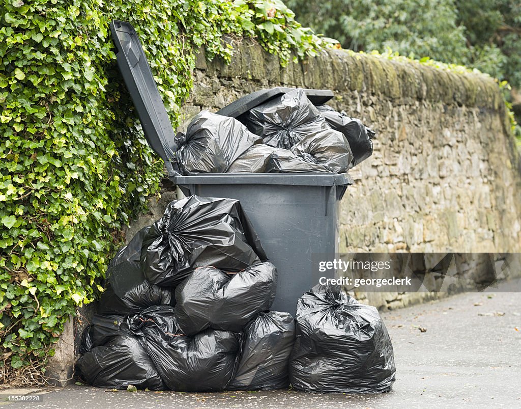 Overflowing Wheelie Bin High-Res Stock Photo - Getty Images