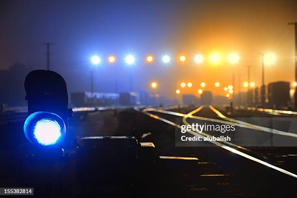 blue signal light - train yard at night stock pictures, royalty-free photos & images