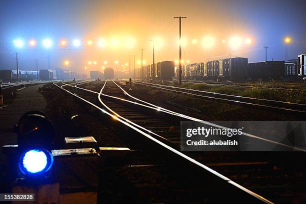 railroad track - train yard at night stock pictures, royalty-free photos & images
