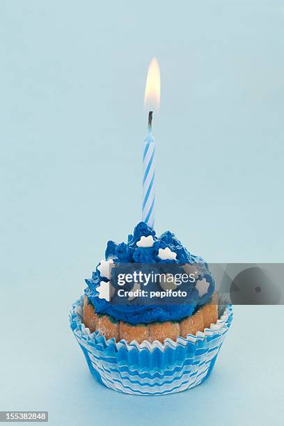 cupcake mit kerze - blue candle stock-fotos und bilder