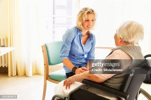 kind care for senio woman patient in wheelchair - community outreach stock pictures, royalty-free photos & images