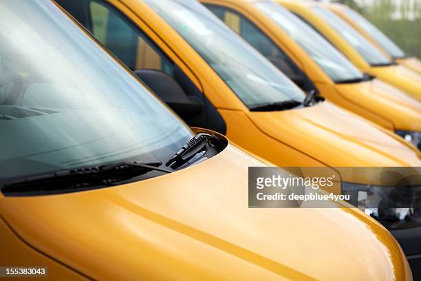 van vehicles in a row - yellow car stock pictures, royalty-free photos & images