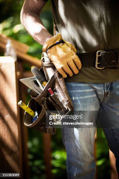 male carpenter wearing tool belt. - construction equipment stock pictures, royalty-free photos & images