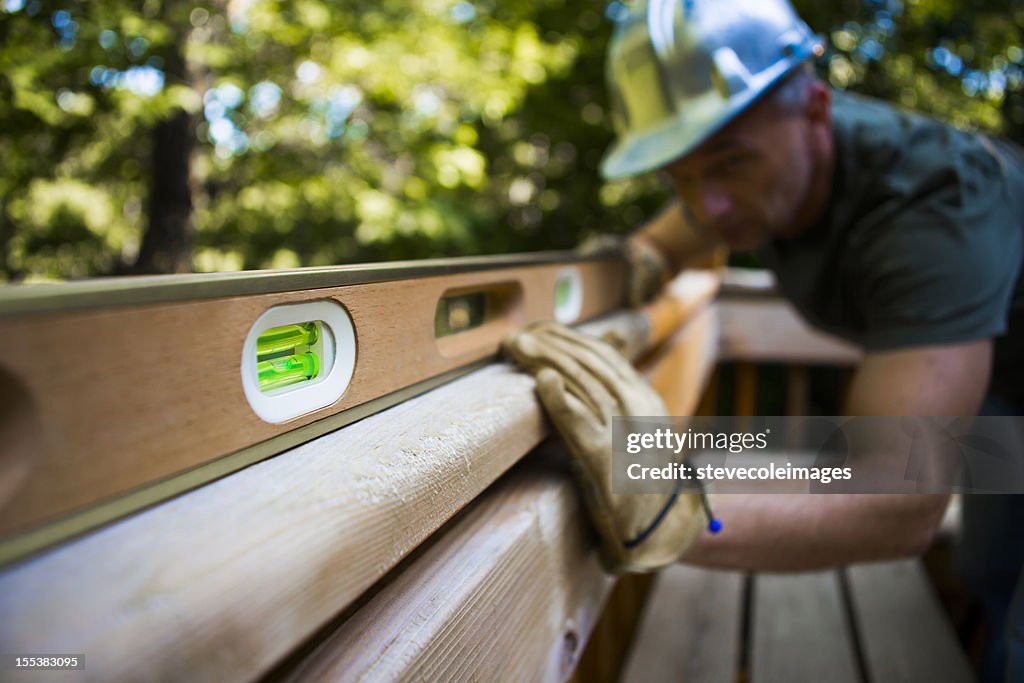 Male Carpenter Working With Spirit Level.