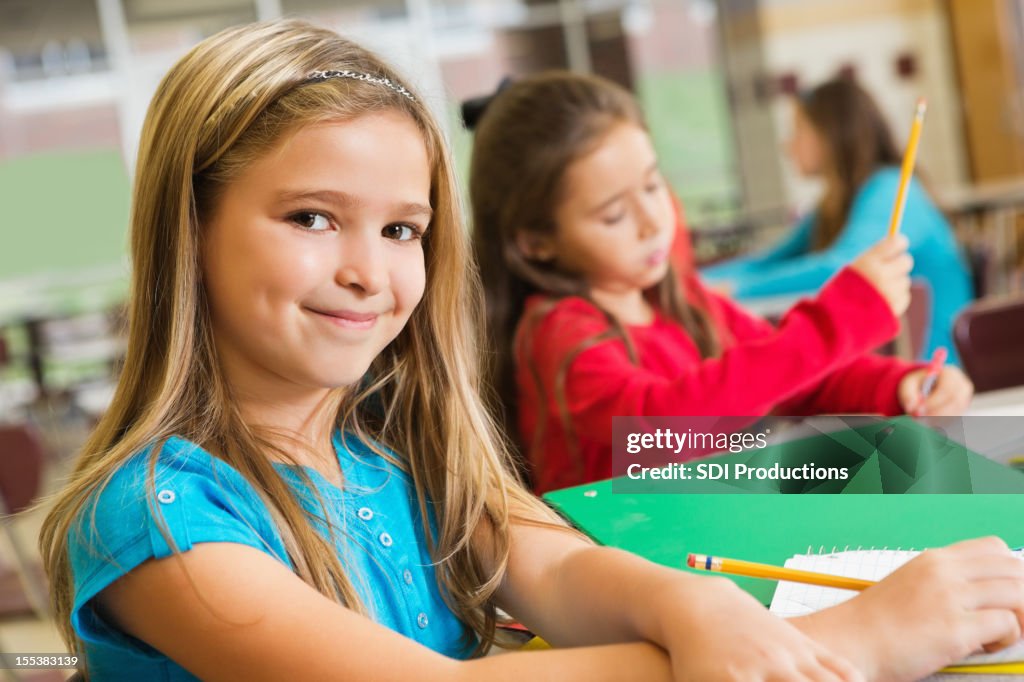 Student Do In Work Happy Elementary Students Doing Schoolwork Together High-Res Stock ...