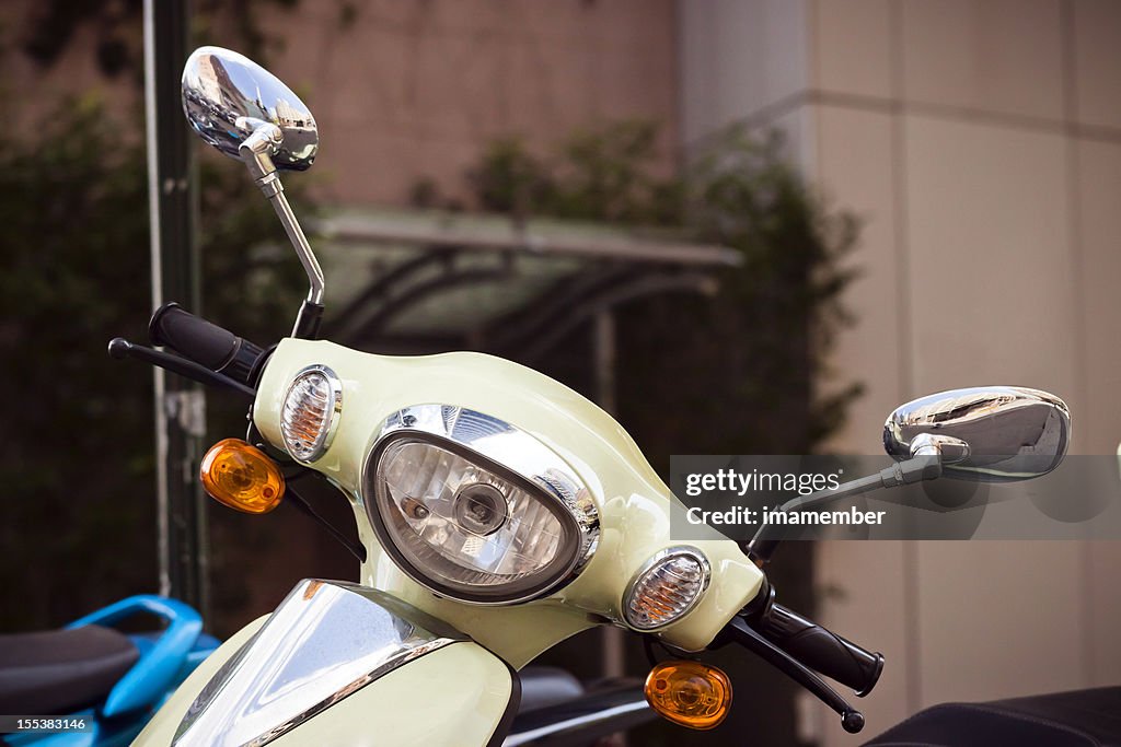 Scooter handlebars with two reversing mirrors and headlight