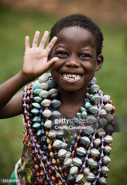 african girl waving - uganda stock pictures, royalty-free photos & images