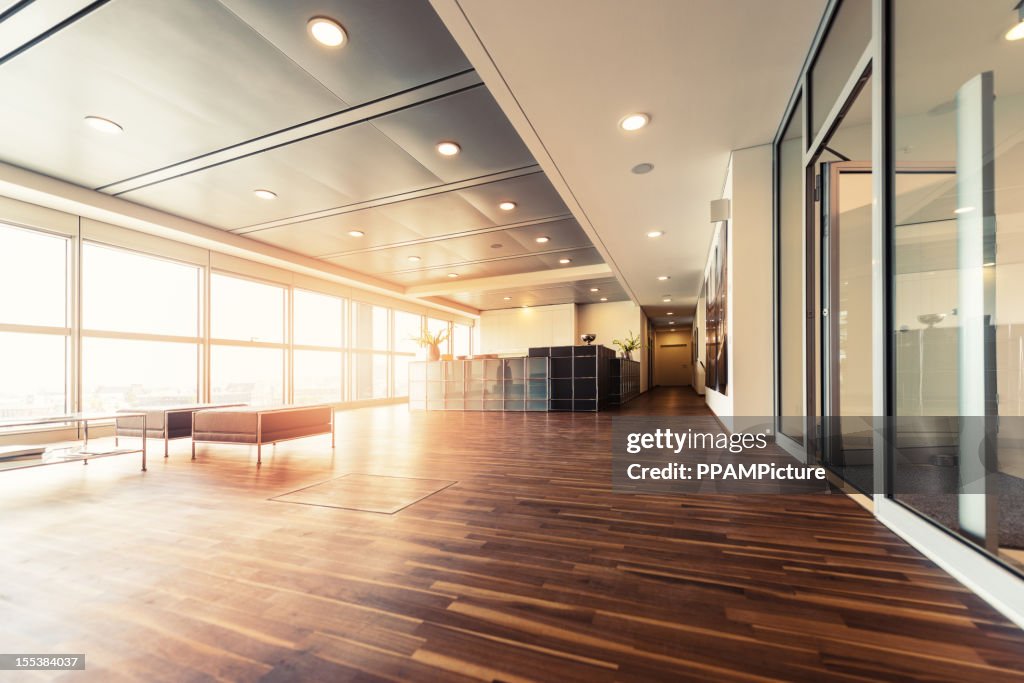 Office reception with wood floors and window wall