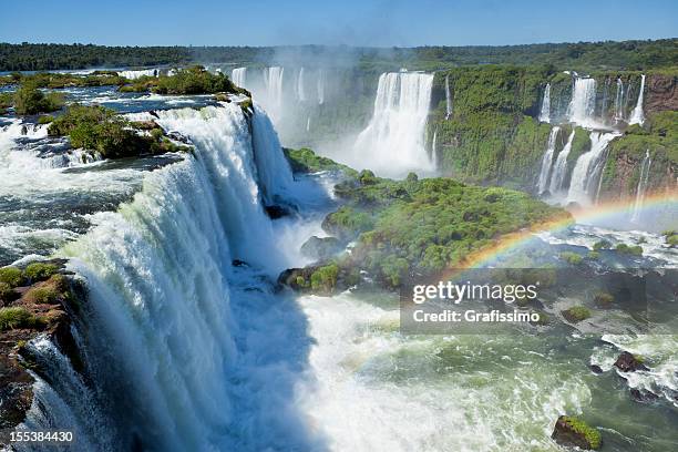 argentina iguazu waterfalls garganta del diablo with rainbow - argentina landmark stock pictures, royalty-free photos & images