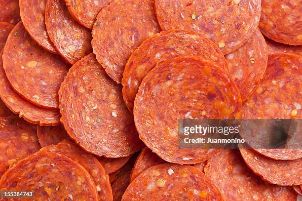 sliced pepperoni background - salami stock pictures, royalty-free photos & images