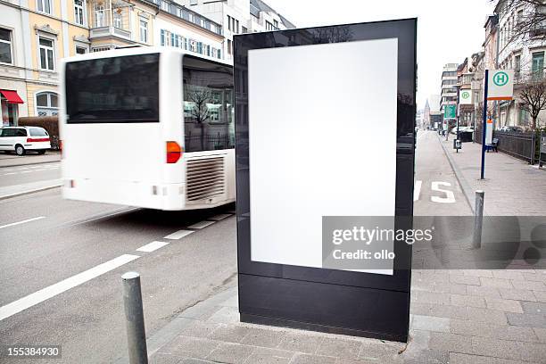 blank advertising billboard on city street, bus passes - billboard bus stock pictures, royalty-free photos & images