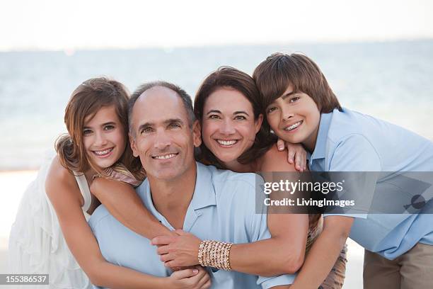 a family taking a family photo on a beach - blue braces stock pictures, royalty-free photos & images