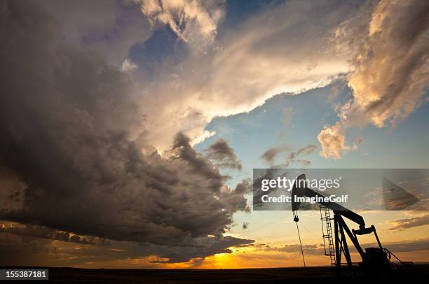 prairie pumpjack silhouette - alberta prairie stock pictures, royalty-free photos & images