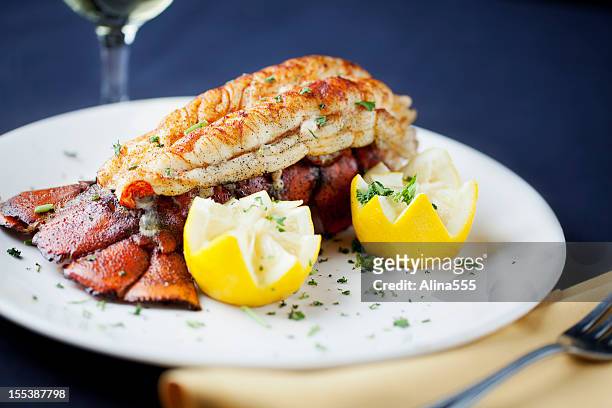 large lobster tail served with white wine - lobster dinner stock pictures, royalty-free photos & images