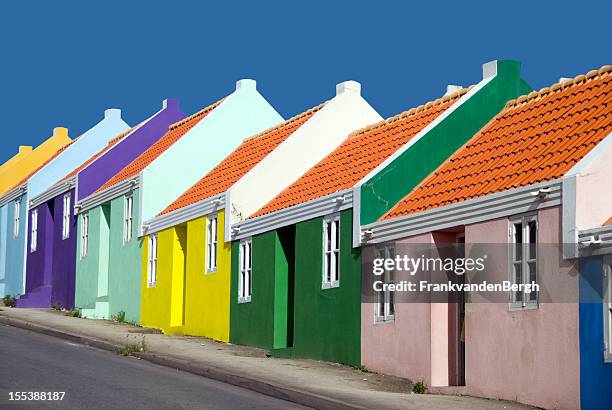 row of colorful caribbean houses - curaçao stock pictures, royalty-free photos & images