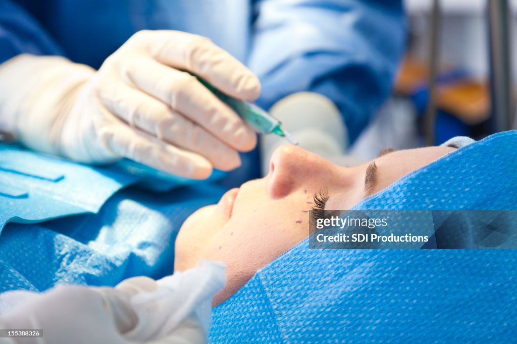 Closeup of woman having plastic surgery performed