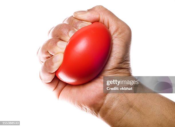 stress ball in hand - stress ball stock pictures, royalty-free photos & images