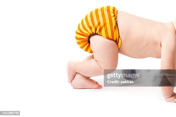 crawling baby lifting cloth diaper high up - crawling stock pictures, royalty-free photos & images