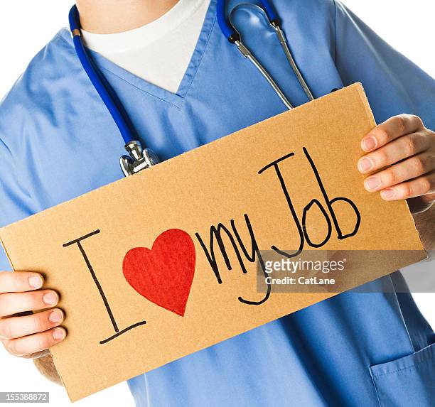doctor with sign: i love my job - nurse recruitment stock pictures, royalty-free photos & images
