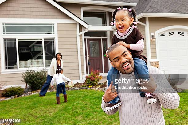 playful family of four at home - front lawn stock pictures, royalty-free photos & images