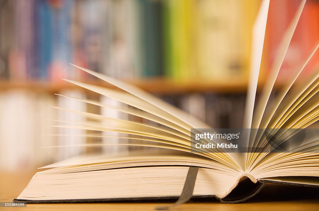 An open book with a leather bookmark